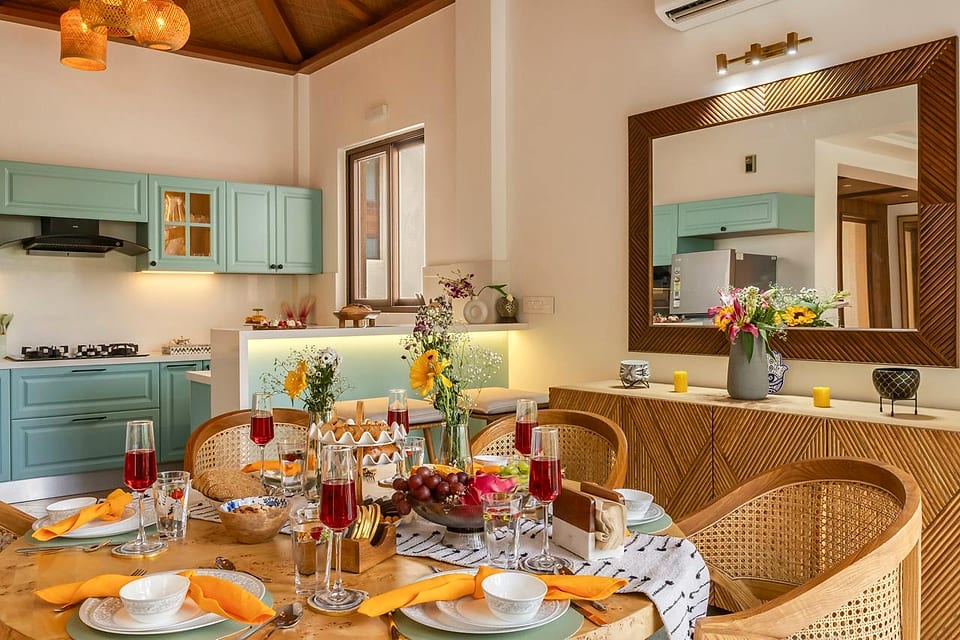 Casa Keval, dining table laid beneath the pendant lights