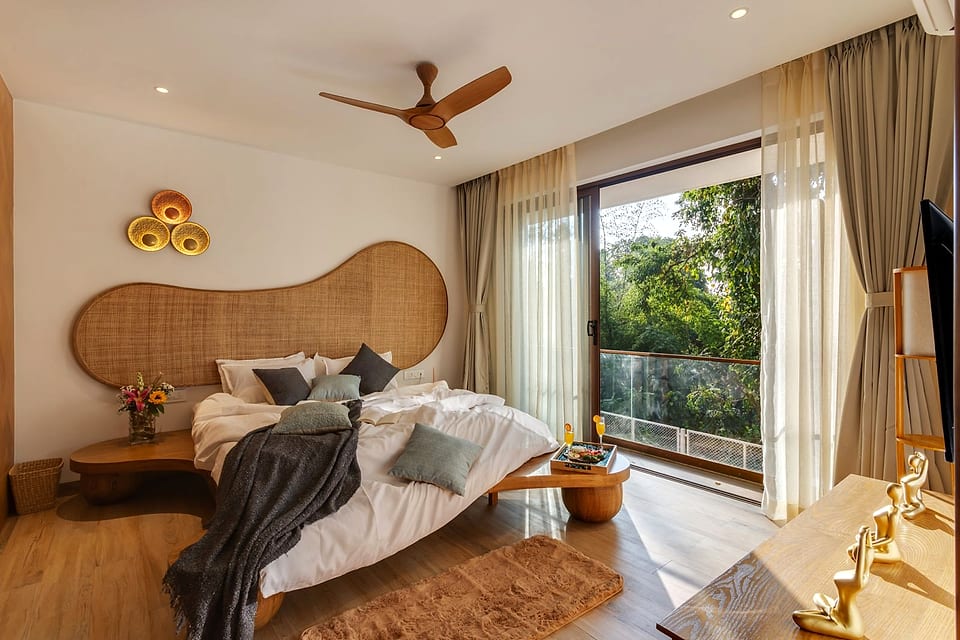 Casa Keval, bedroom with a rattan bedhead and reading lamp
