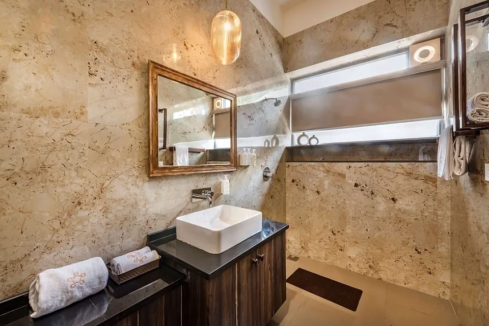 Nerul residence, stone-clad vanity and mirror